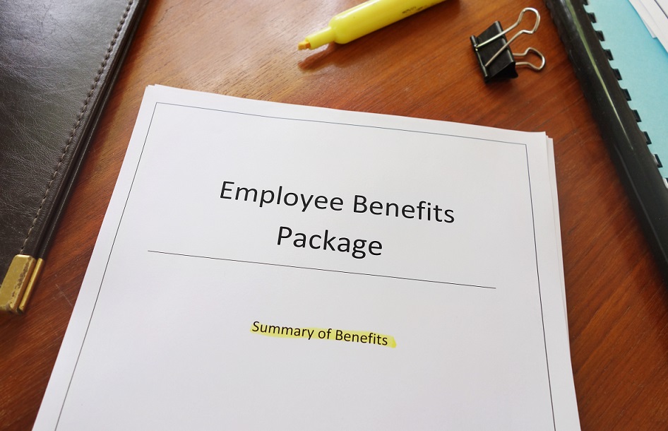 Paper file on a desk entitled Employee Benefits Package