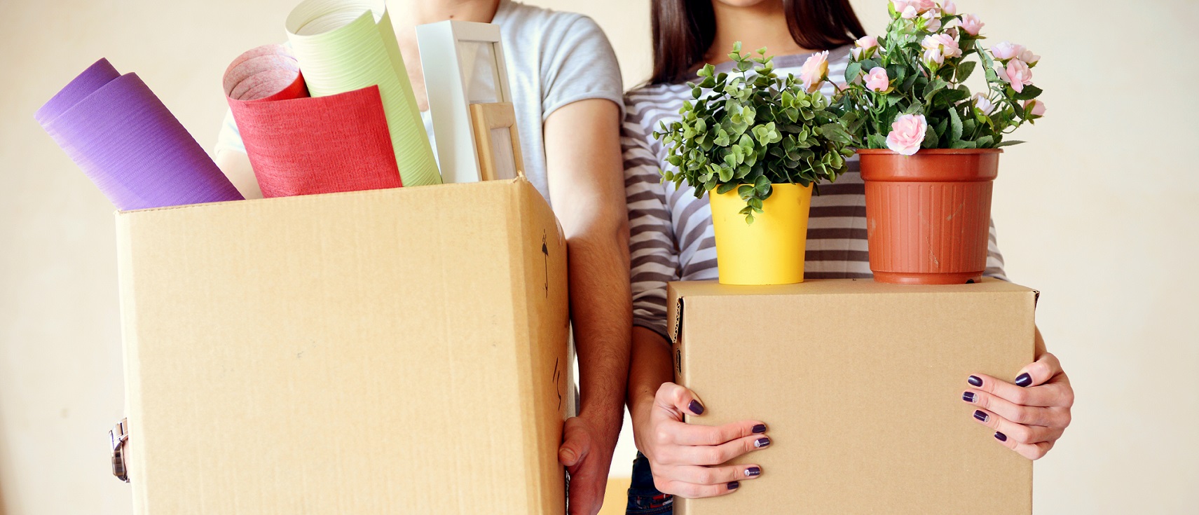 Couple holding moving boxes
