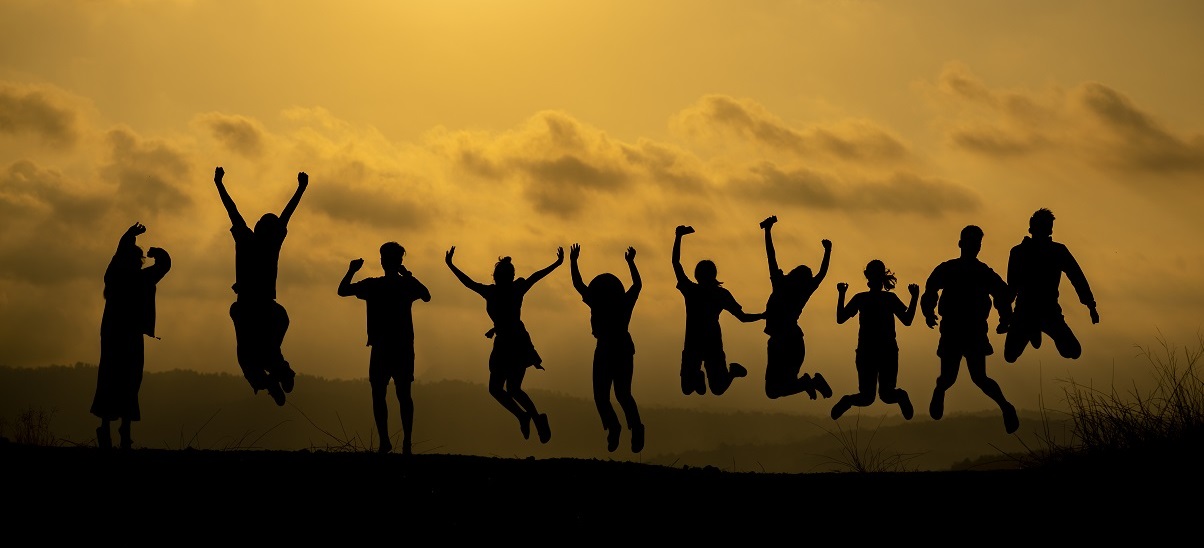 Silhouette of happy people jumping